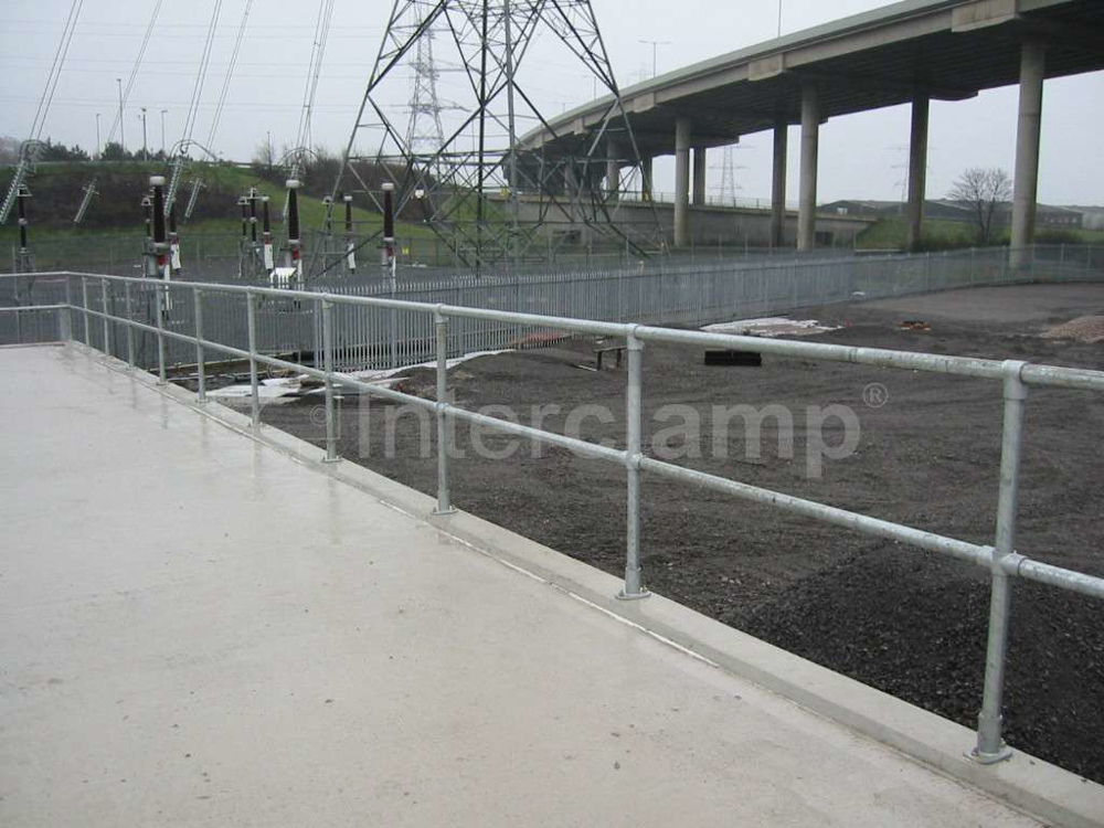 Secure safety guardrailing constructed from Interclamp pipe clamp fittings and tubes at a civic amenity and recycling facility, ensuring public safety and organisation.